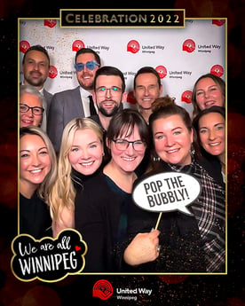 Eleven Payworks staff in a photo booth.