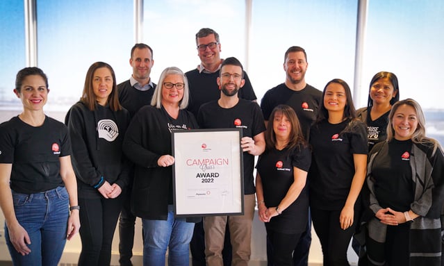 Eleven Payworks staff holding 2022 Campaign Chair's Award.