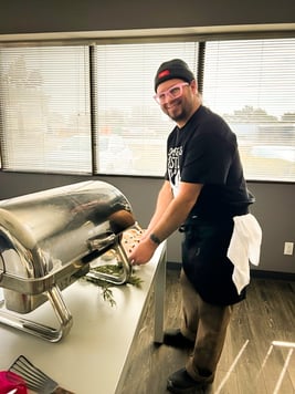 A individual standing at a row of hot plates.