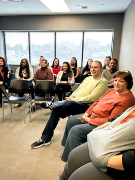 Twelve Payworks staff sitting in a crowd. 