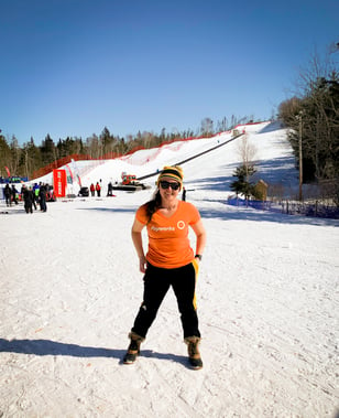 A Payworks staff on a ski hill. 