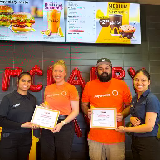 Two Payworks staff receiving certificates from two McDonald’s staff. 