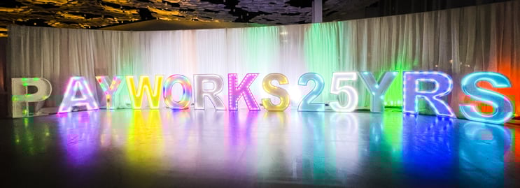 Light-up letters and numbers spelling “PAYWORKS25YRS”. 