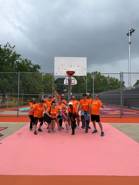 Sebastien Beetz (third from the right) poses with his team members of the Payworks Quebec team pose on the basketball court mural at Parc Martin Luther King in Montréal. 