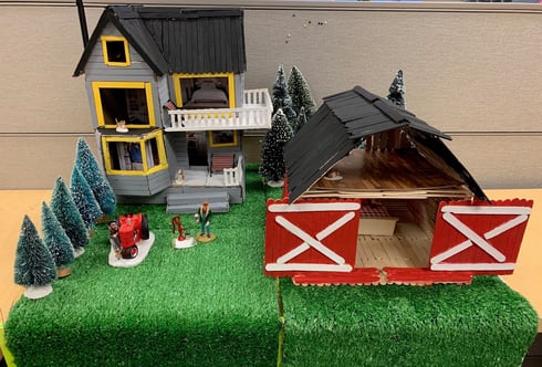 Popsicle stick house with barn.