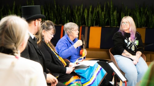 Three Blanket Exercise facilitators sitting beside a Payworks’ staff member in a row of chairs.