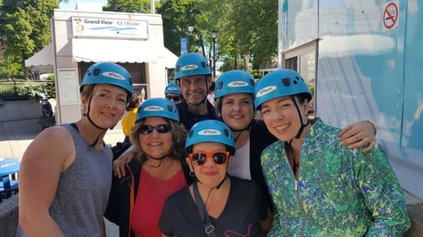 Six individuals ready to go on a zip line.