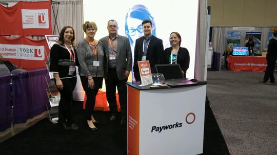 Five Payworks staff at the Payworks tradeshow booth.