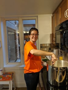 Payworks staff cooking in a large pot.