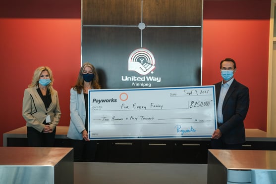 United Way Winnipeg Vice President Community Impact Kathy Knudsen and United Way Winnipeg President and CEO Connie Walker with Payworks President & CEO JP Perron holding a large cheque for $250,000. 