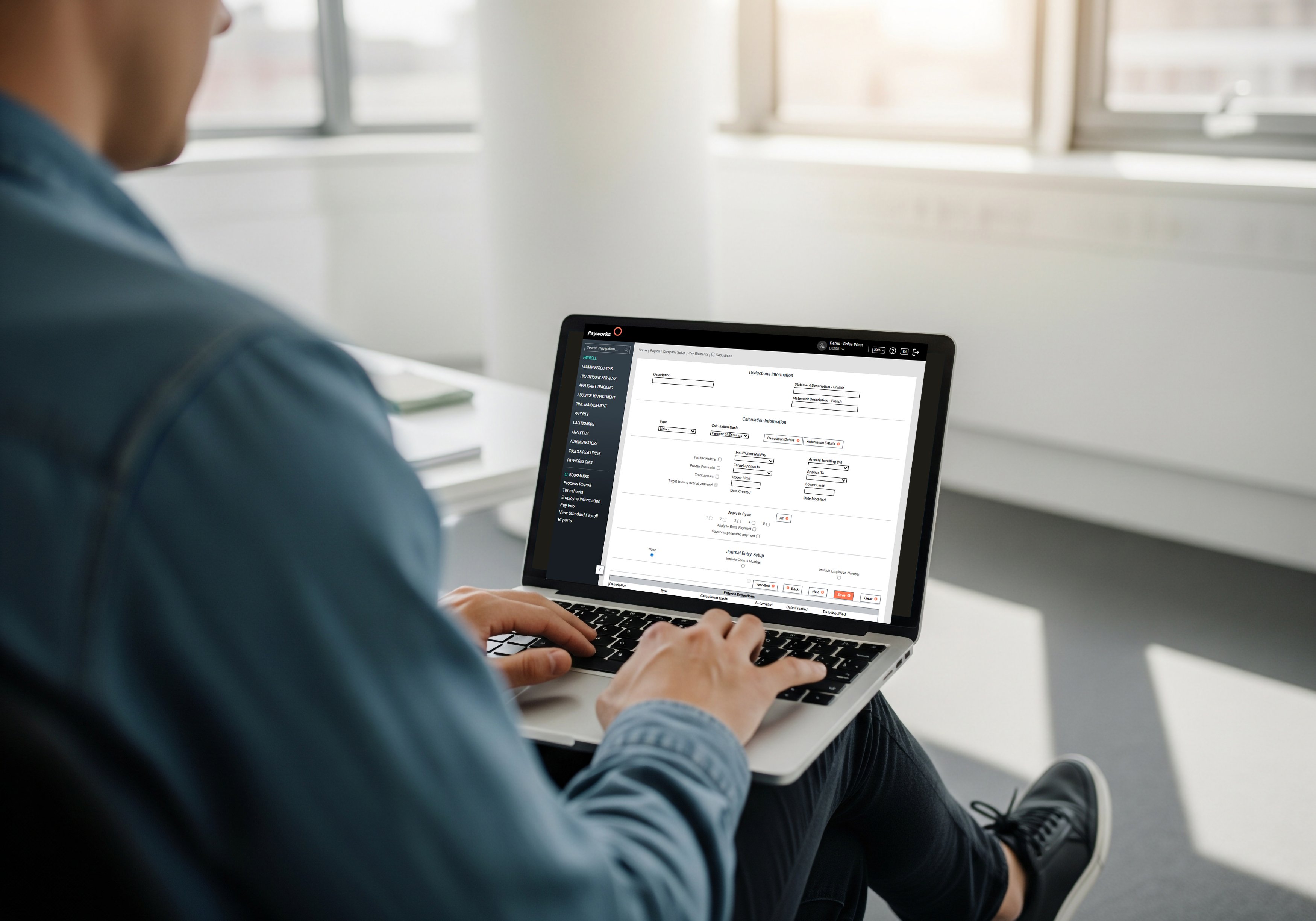 A person types on a laptop, and on the screen we see the Payworks deduction information screen.