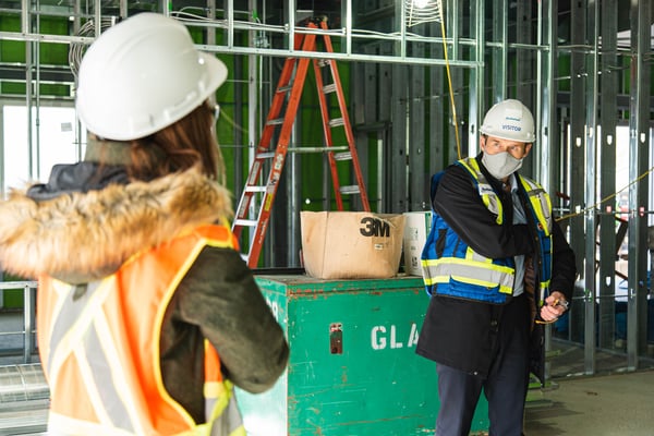 Two individuals in construction equipment.