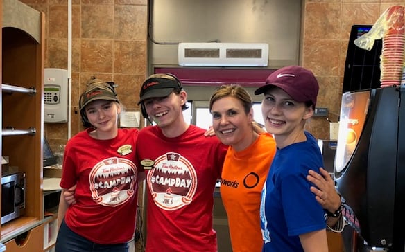 One Payworks staff with three Tim Hortons staff members. 