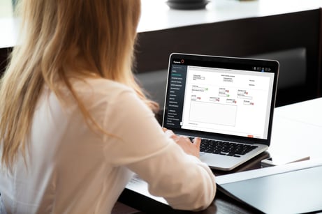 A woman using a laptop computer, navigating the Health & Safety Incidents screen in Payworks Human Resources solution. 