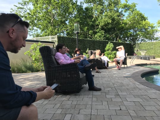 Payworks staff sitting by the pool.