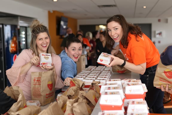 Three Payworks staff with Big Macs.