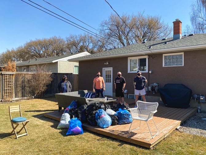 Members of the Payworks' Sales Team in Calgary dropping off clothing donations for CPAA.