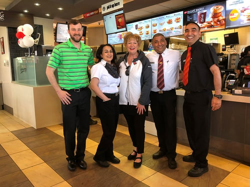 Two Payworks staff with three staff from McDonalds. 