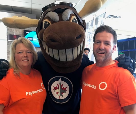 Two Payworks staff with Mickey Moose mascot.