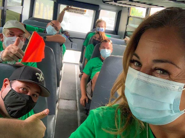 Eight Payworks staff taking a selfie on a bus ride. 