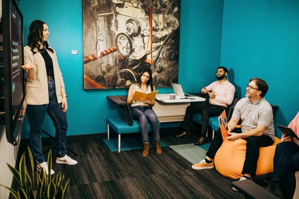 A group of Payworks employees meet in a collaboration space. 