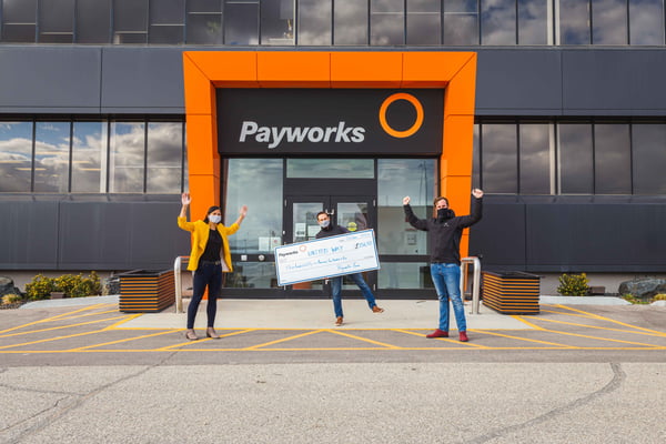 Three Payworks staff with a large cheque.
