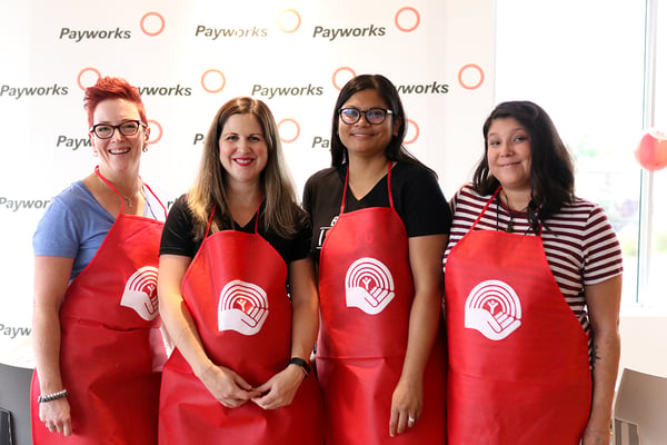 Four Payworks staff members wearing United Way aprons.