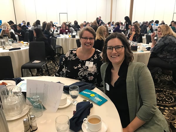 Two staff members at a table. 