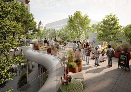 A rooftop patio filled with people of all ages and surrounded by leafy trees.