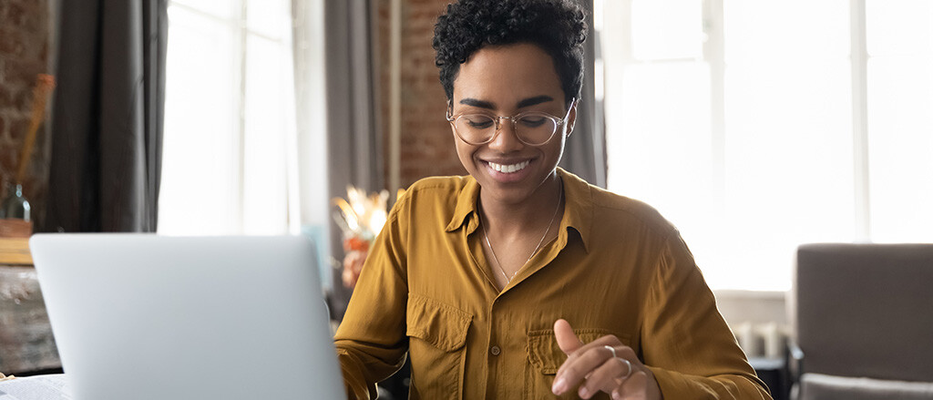 A woman working at a laptop accompanied by text that reads, “7 internal payroll controls every company should have”. 