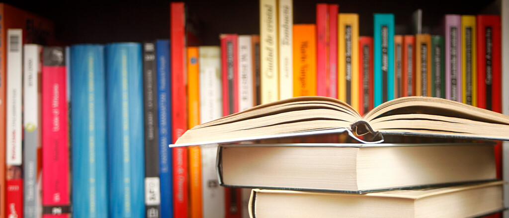 A book shelf lined with books accompanied by text that reads, “Checking in with our COO for his Book Lovers Day recos”. 