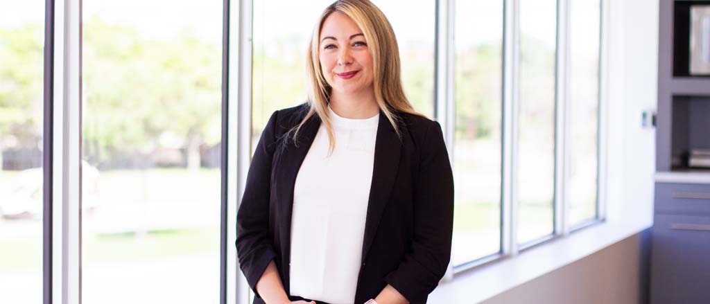 Text reads, “Jennifer Johnston. VP of HR with a teetering TBR book pile”.  