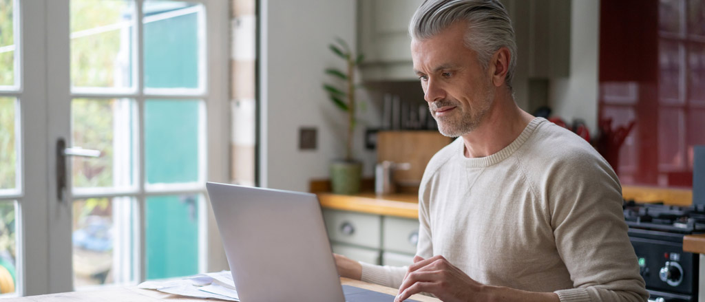 Man working at home on his laptop computer 