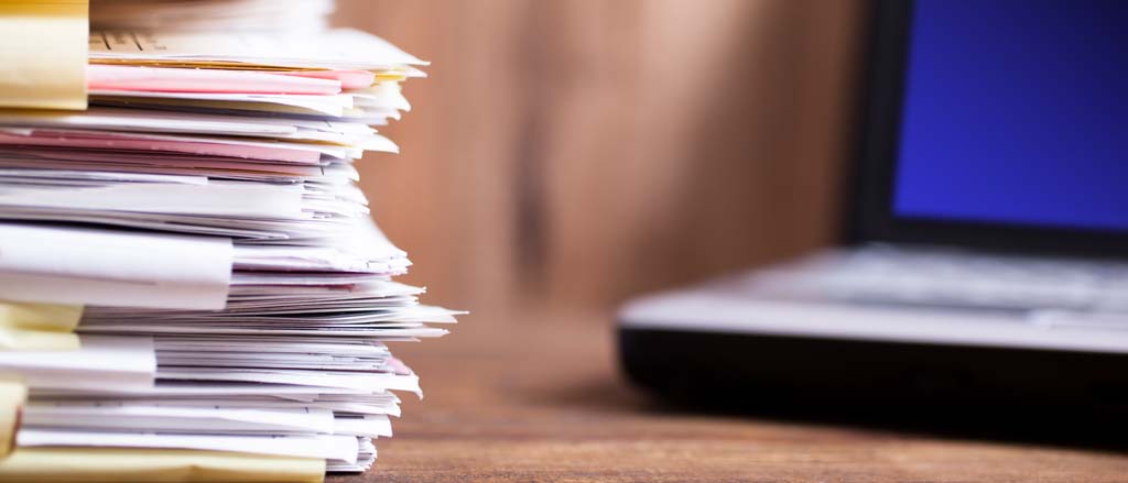 A stack of papers accompanied by text that reads, “how businesses can adopt greener processes with us”.  