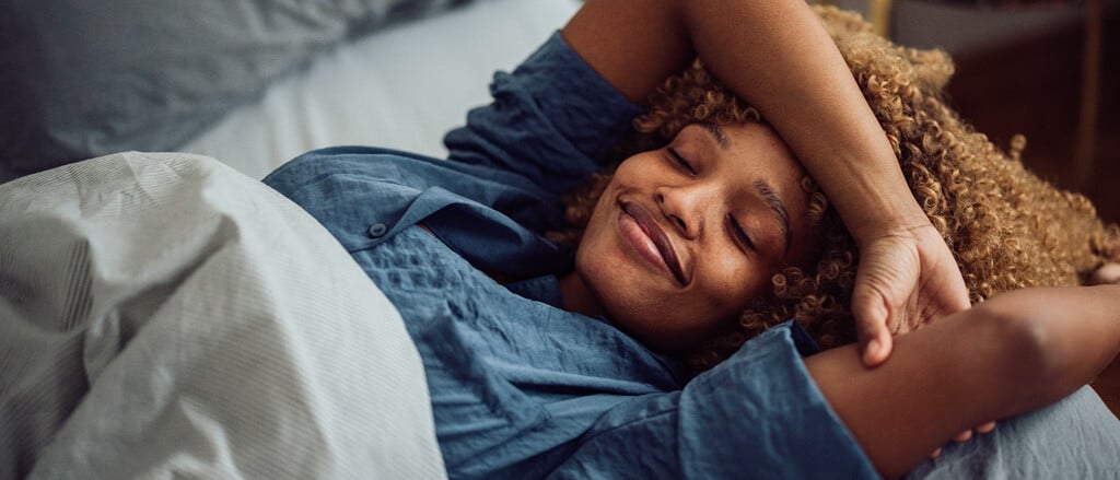 A woman resting in bed accompanied by text that reads, “focus on various types of rest to improve your sleep (& mental health!)”.  