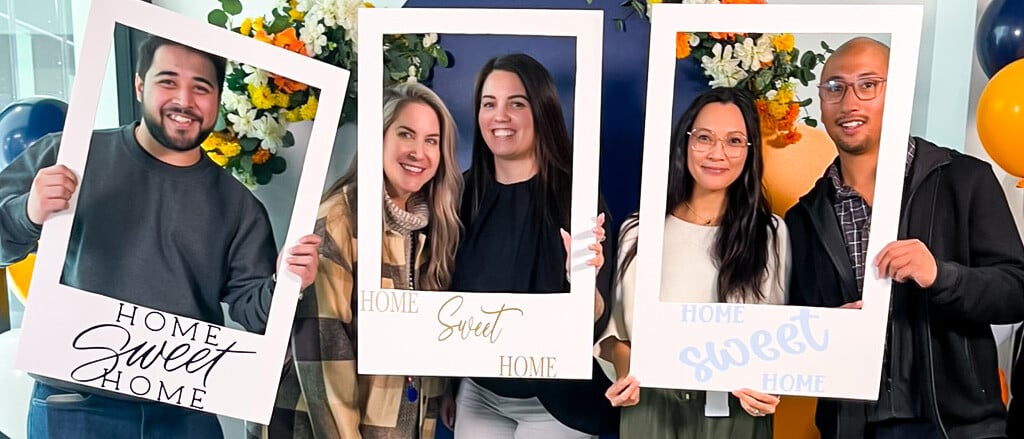 Five Payworks staff in a photobooth accompanied by text that reads, “attn: Head Office now open! Check out our new space”.  